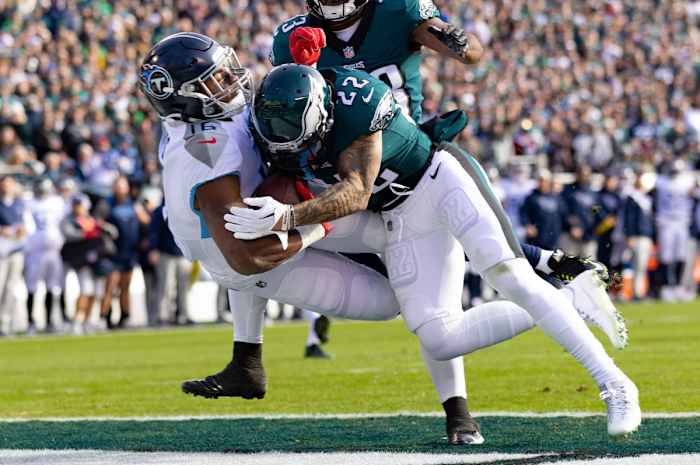 Tennessee Titans wide receiver Treylon Burks (16) is hit by Philadelphia Eagles safety Marcus Epps (22) as he makes a touchdown catch during the first quarter at Lincoln Financial Field.
